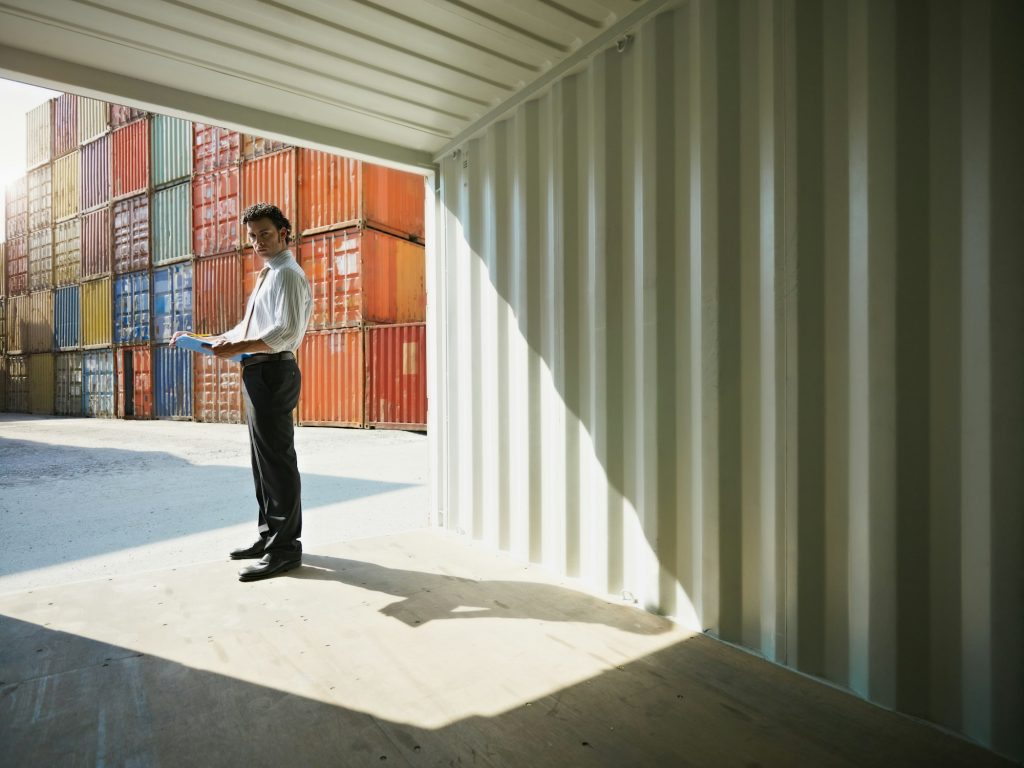 business man with shipping containers